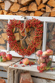 Rosehip heart hung on old window frame