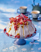 Pavlova with mixed fruit and passion fruit sauce