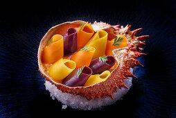 Colourful carrot strips with sabayon in a spider crab shell