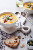 Sweet potato soup with crispy bread and pumpkin seeeds