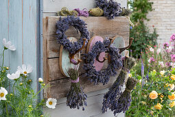 Lavender wreaths and bouquets on hooks on the terrace