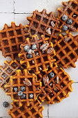 Homemade spicy pumpkin waffles with fresh blueberries and powdered sugar