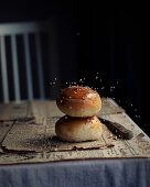 Airy buns with sesame seeds on newspaper