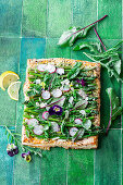 Green asparagus tart with radishes and herbs