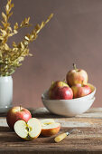 Apples on a wooden board and in a bowl