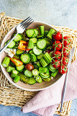 Summer vegetable salad with okra and sesame seeds, served with vine tomatoes