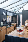 Kitchen with skylights and grey wood paneling