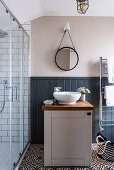 Round mirror above vanity in bathroom of converted Victorian railway carriage