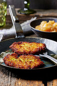 Potato pancakes in the pan with apple sauce