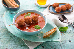 Tomato soup with vegan soy meatballs on skewers