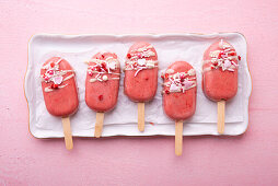Vegan cake pops covered in pink rice milk chocolate icing