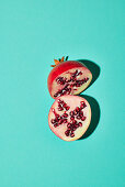Halved pomegranate on a turquoise background