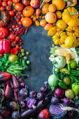 Fruit and vegetables in rainbow colors creating a picture border with copy space