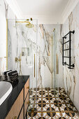 Bathroom, walls of white imitation marble tiles, vanity with integrated sink, and shower
