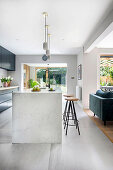 Kitchen island with bar stools in open-plan living room