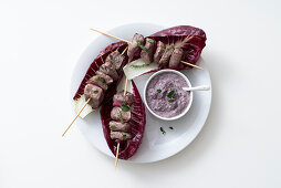 Duck breast skewers with red onions and radicchio cream