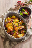 French potato casserole with bacon, mushrooms, and peas