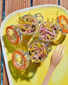 Raw vegetable salad in glass jars