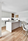 Modern, white kitchen, and dining area in coastal style