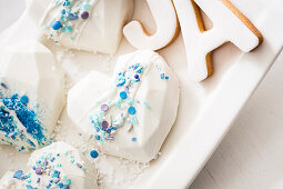 Heart-shaped cakes with white fondant and blue sugar sprinkles