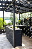 Outdoor kitchen with wooden paneling and string lighting