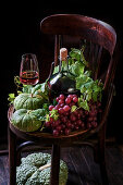Autumn composition with wine and green pumpkins and grapes