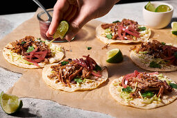 Carnitas tacos with pickled red onions