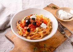 Pasta with eggplant tomato sauce and vegan herbed cream