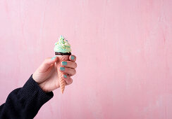 Chocolate cake baked in an ice cream cone with vegan butter cream