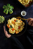 Baked pumpkin ricotta pasta from the oven with sage and olive oil