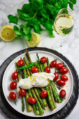 Roasted green asparagus with burratini, cherry tomatoes, and lemon