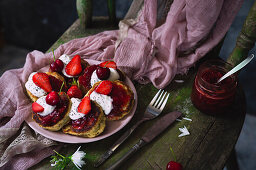 Poppy seed pancakes with cherries, strawberries, and yogurt