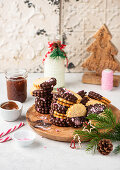 Nut nougat sandwich cookies dipped in chocolate with crushed candy cane