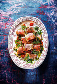 Lake trout saltimbocca with herbs, ham and pesto