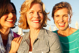 Three good-humoured girlfriends on a ship