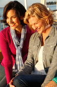 Three good-humoured girlfriends on a ship