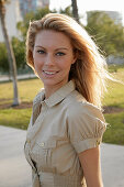 Blonde woman in light blouse dress outside