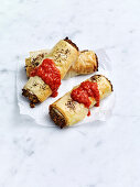 Lentil sausage rolls with tomato sauce
