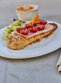 Breaded escalope with ham and tomatoes, leek salad and sweet potato