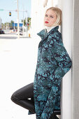 Young blonde woman in transitional coat with leaf jacquard