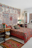 Colorful fabrics in the bedroom with wooden table next to the bed