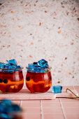 Colorful jello with fruit in a glass