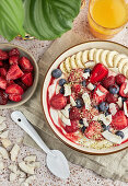 Yogurt-Breakfast-Bowl with fruit, hemp seeds and coconut chips