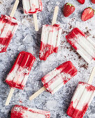 Strawberry and coconut ice cream on a stick