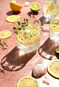 Water with thyme, lime, lemon, and ice