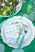 Summer table setting with sprig of flowers and small label