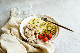 Pork cutlets in sour cream sauce with mashed potatoes and vegetables