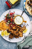 Souvlaki from the hot air fryer with yoghurt dip, salad and pita bread
