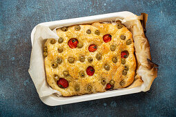 Focaccia with green olives, olive oil, cherry tomatoes and rosemary
