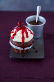 Chocolate cupcakes with vanilla topping and cherries